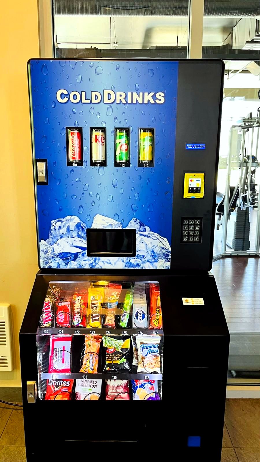 Close-up of a CanBite combo vending machine with drinks, snacks and card reader
